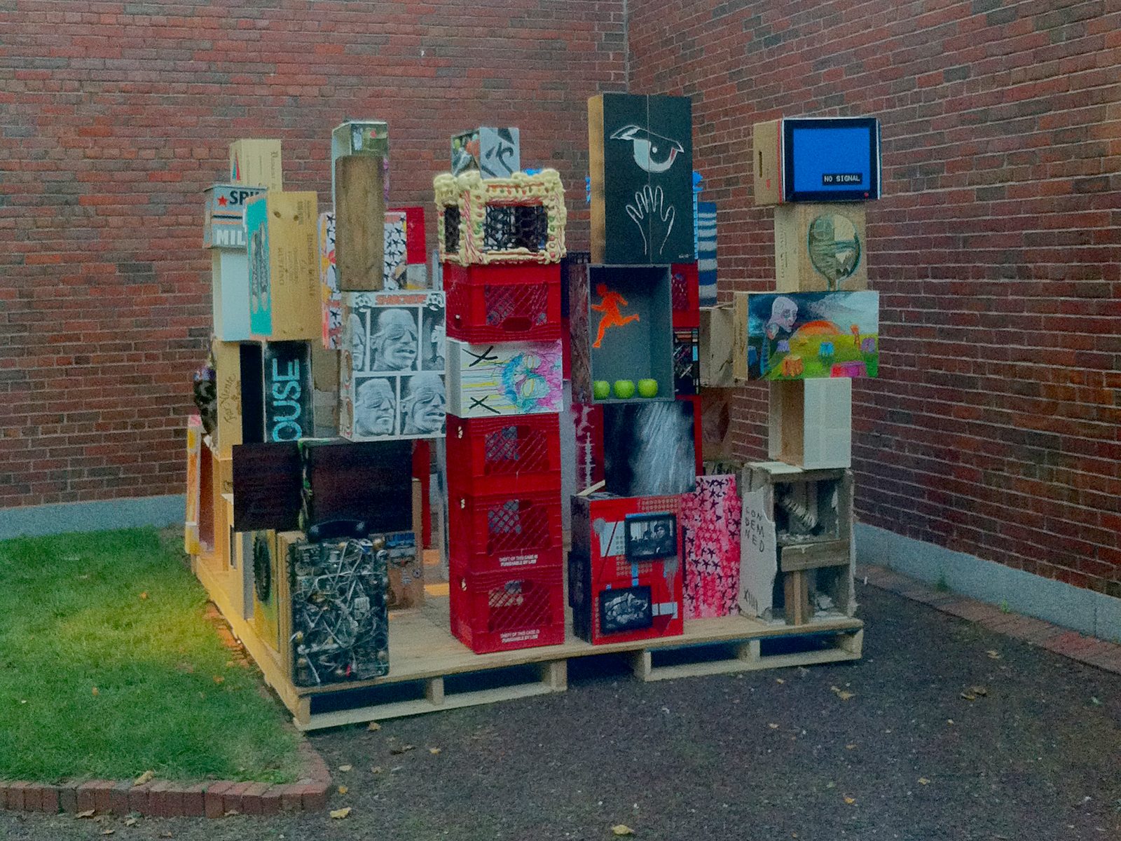 Piece Work, a collaborative installation of stacked painted crates and boxes at the Portland Museum of Art Biennial, 2013, with a piece by Brenden Sanborn