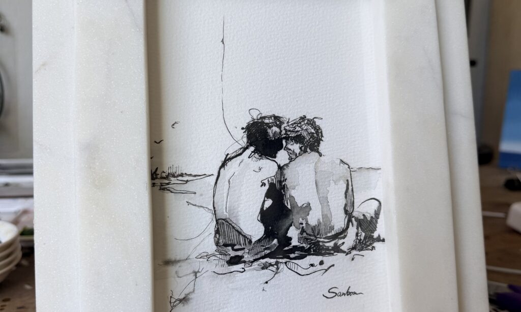 Brenden Sanborn's 5 by 7 ink drawing of two men on the beach in a white marble frame