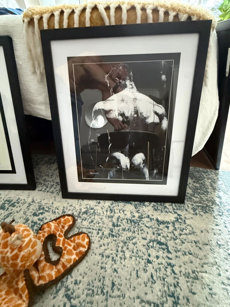 Black and white male back art print by Brenden Sanborn hanging in a collector's home