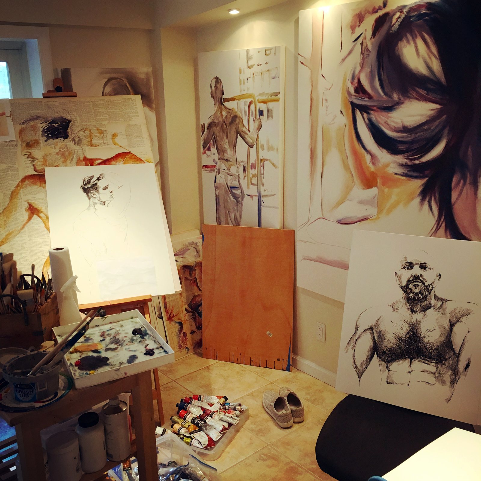 Brenden Sanborn's Fort Lauderdale studio with large paintings on every wall and an easel in the middle