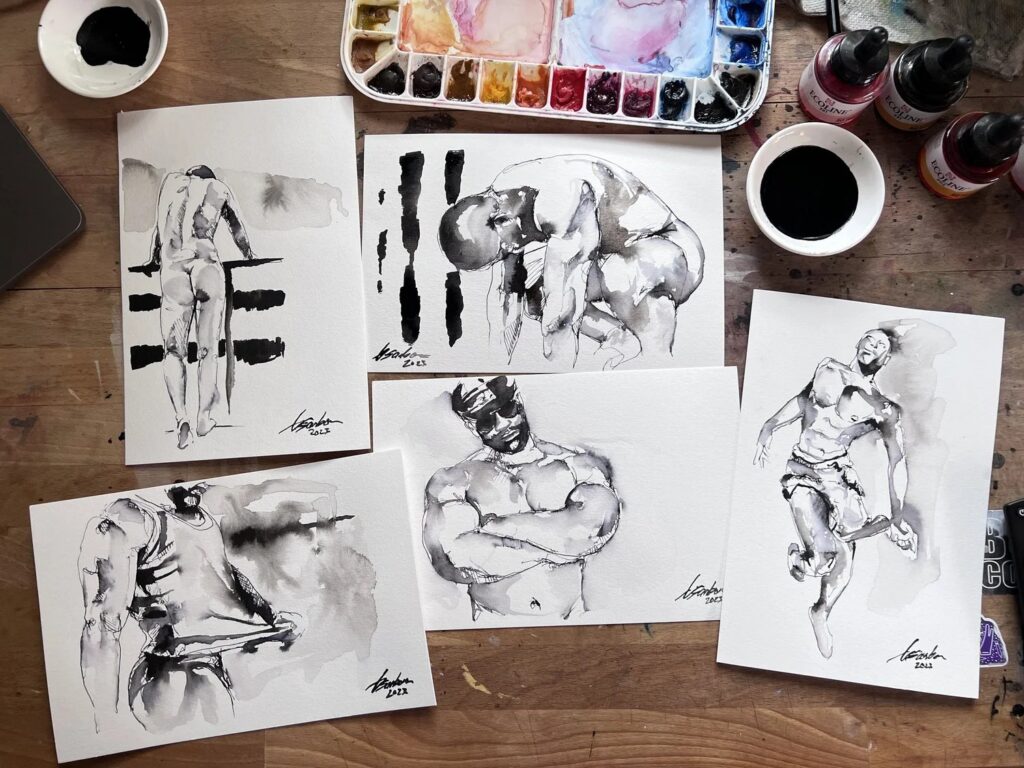 Five Tuesday ink sketches of male figures by Brenden Sanborn laid out beside his watercolor palette and ink