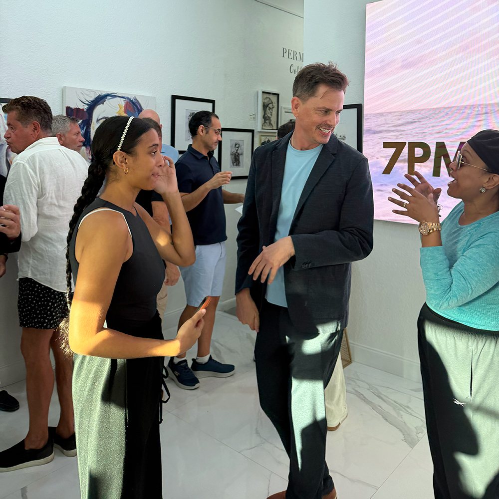 Brenden Sanborn laughing and talking with guests inside Space Untitled Art Gallery at the Unspoken opening